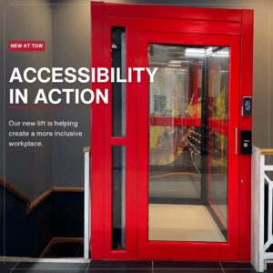 Bright red accessibility lift installed at The Document Warehouse, with text highlighting its role in creating a more inclusive workplace.
